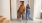 a man and woman walking past a staircase in an apartment