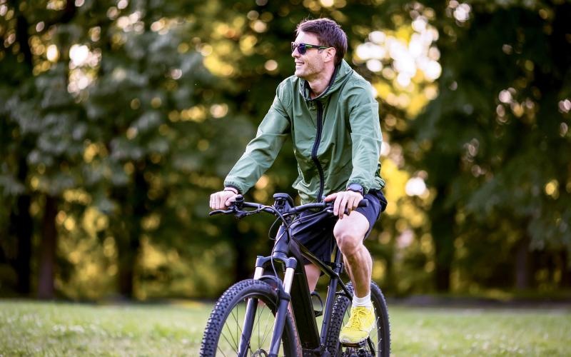 a man riding a bicycle in local park