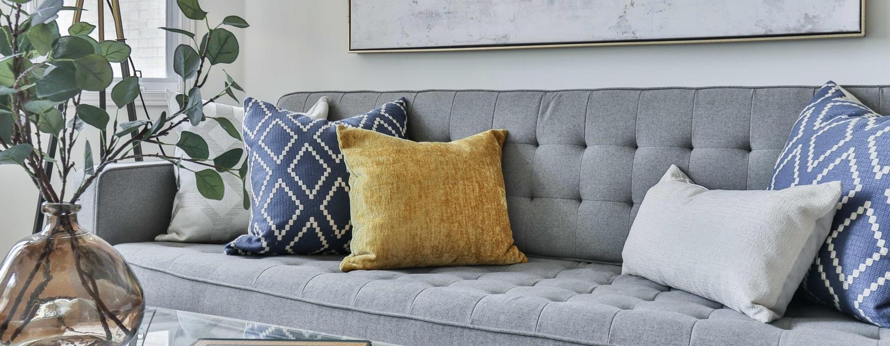 a couch with pillows and a coffee table