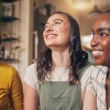 girlfriends laugh in their apartment together