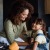 mother and little girl sit in their kitchen