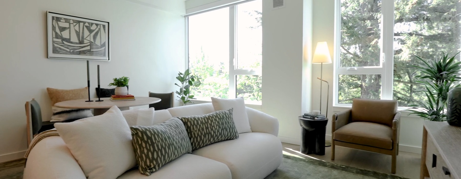 living room with couch coffee chair and large windows