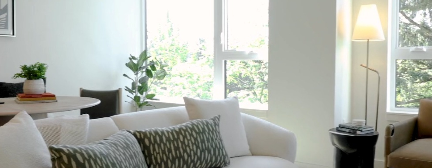 living room with couch coffee chair and large windows